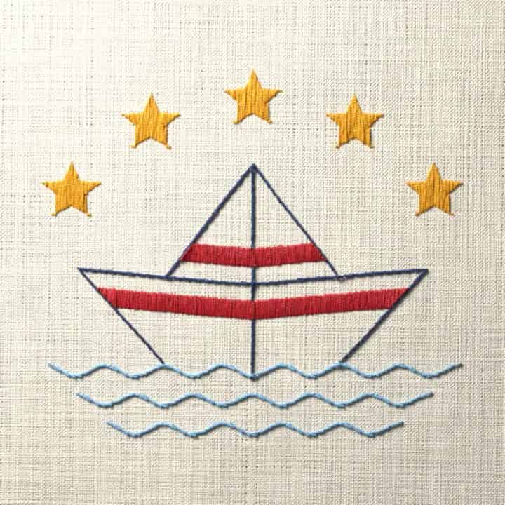 Paper boat under five stars: preview of the stitched design