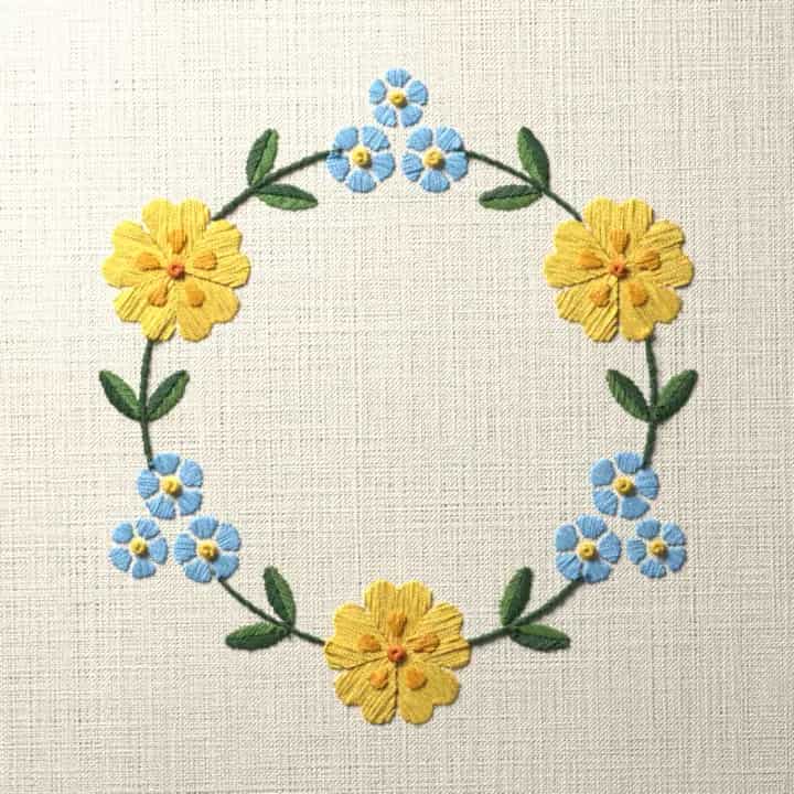 Primrose and forget-me-not wreath: preview of the stitched design