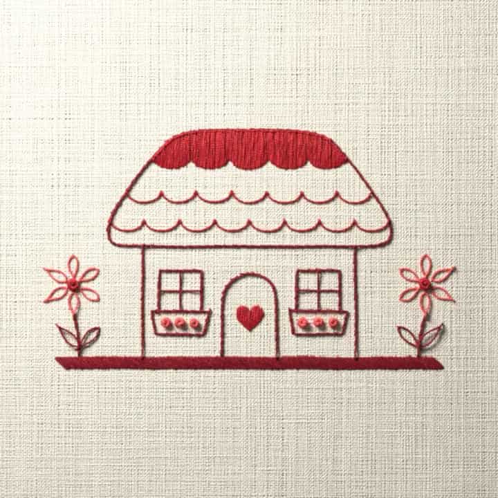 Thatched cottage in three reds: preview of the stitched design