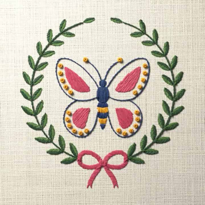 Butterfly in a laurel wreath: preview of the stitched design