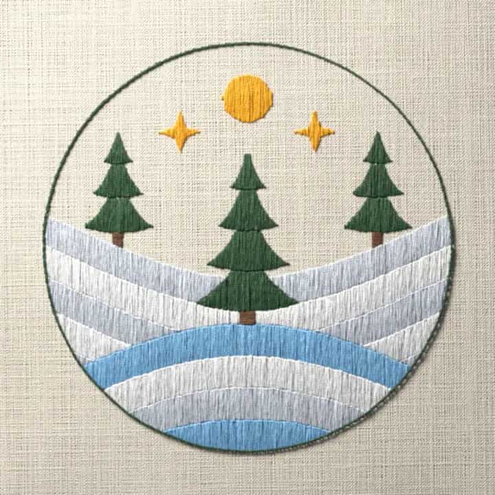 Snowy winter pine trees: preview of the stitched design