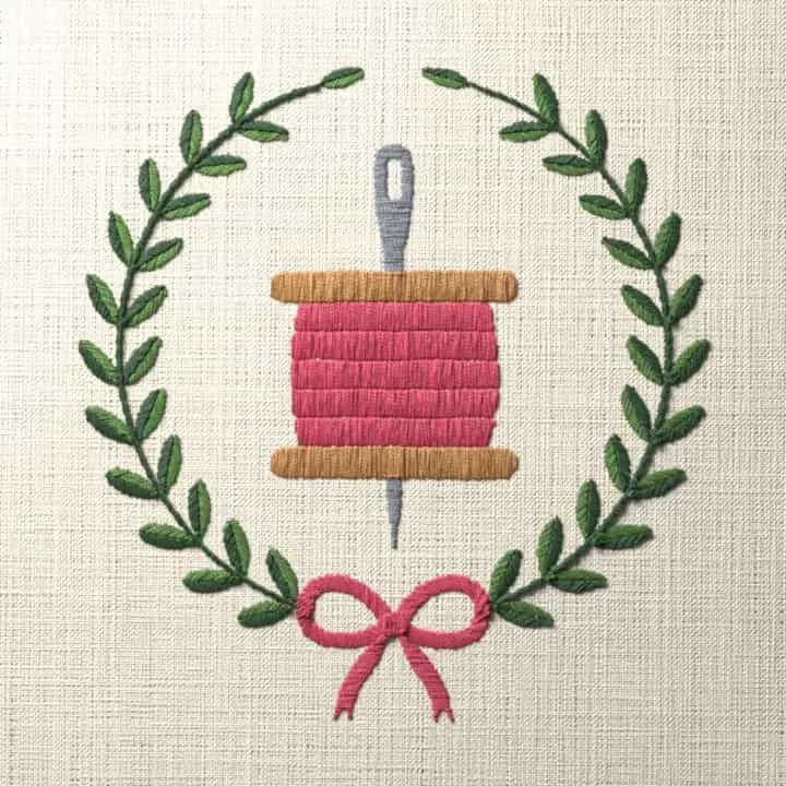 Spool of thread in a laurel wreath: preview of the stitched design